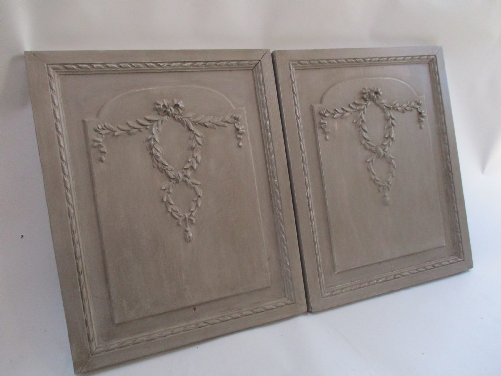 A pair of grey painted wooden cabinet doors decorated with hand-carved laurel wreaths and ribbon swags. View III