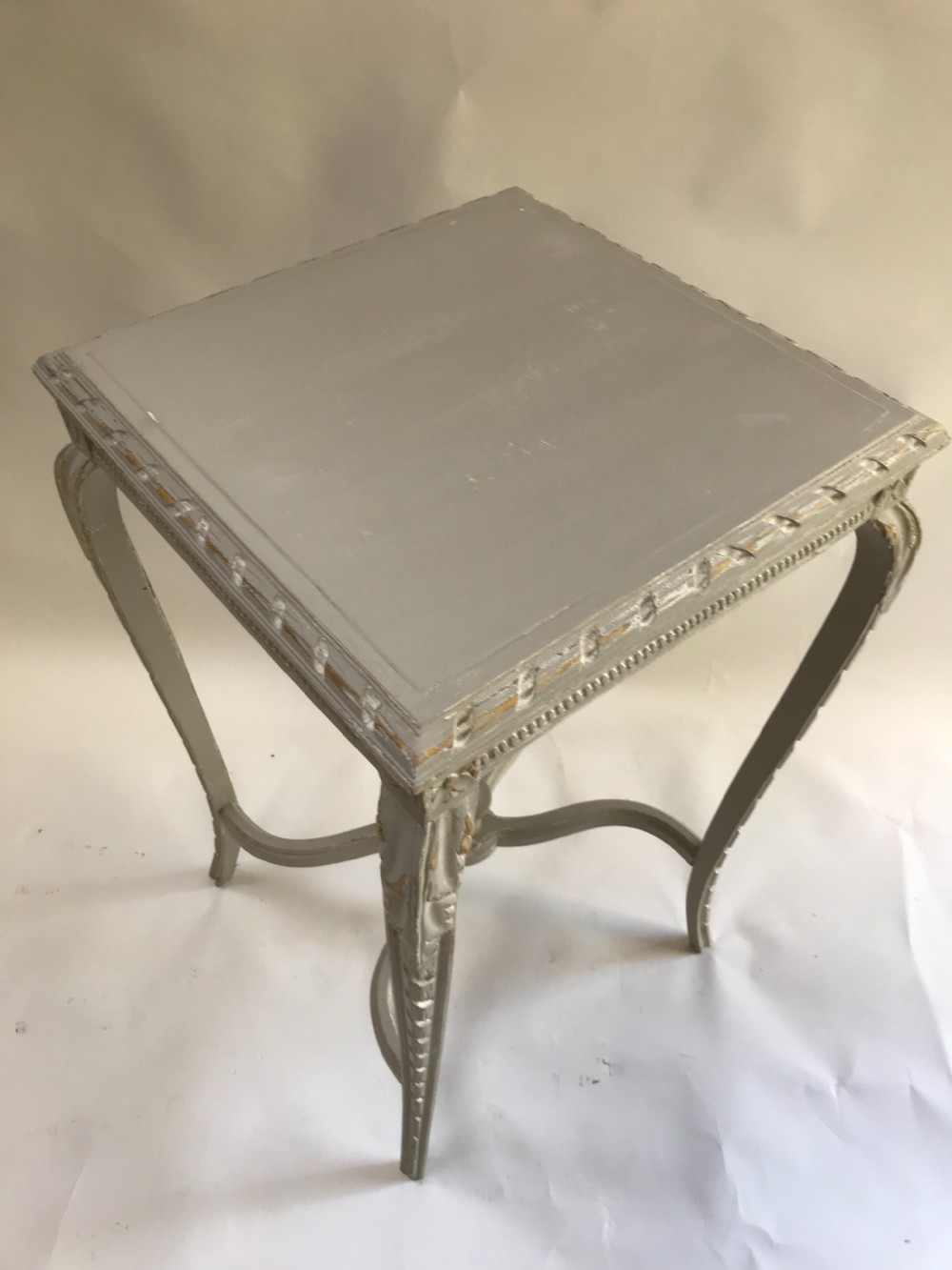 A light grey painted square side table featuring carved cabriole legs, a beaded apron, and an X-shaped stretcher with a central finial. View IV
