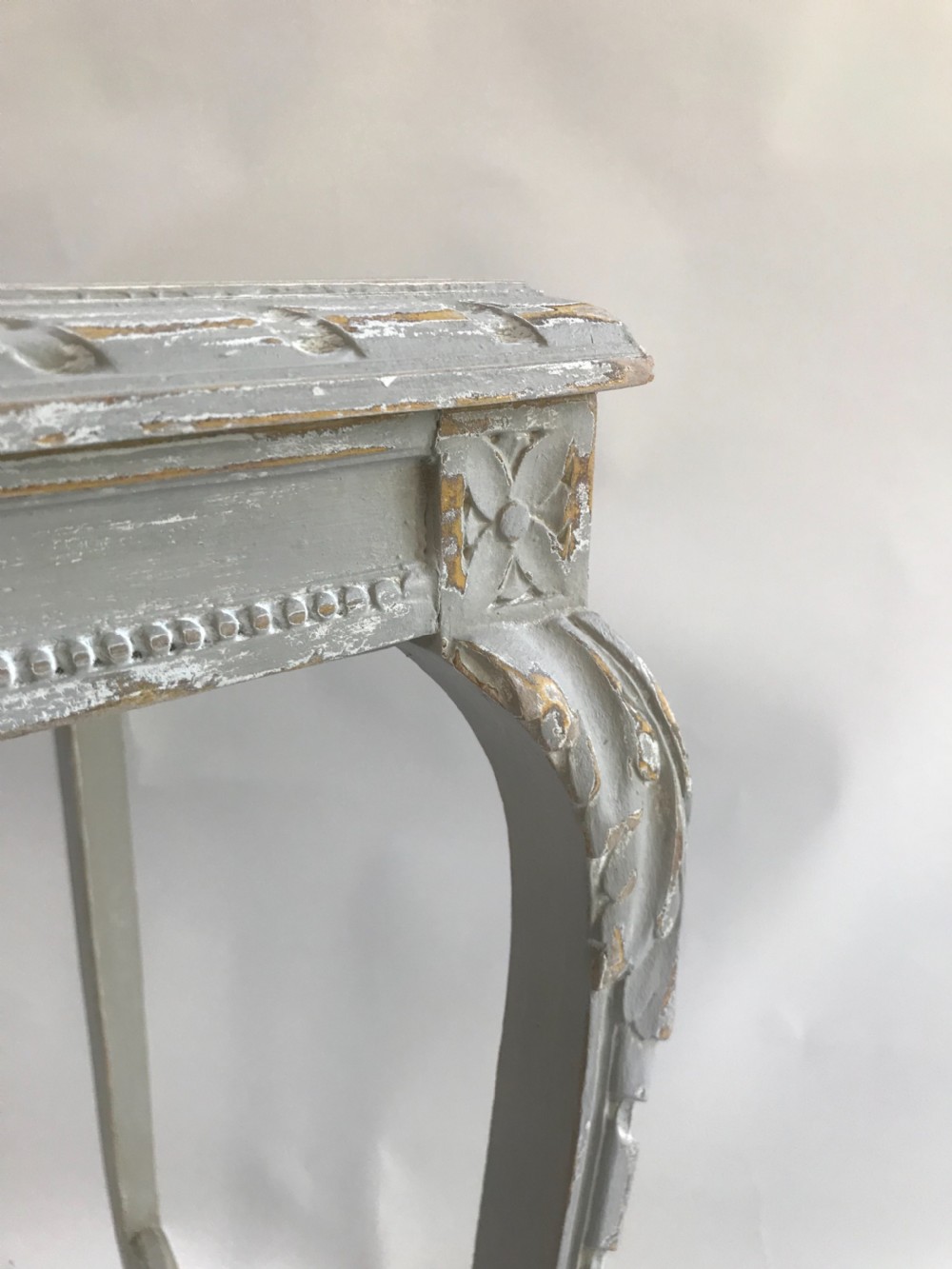 A light grey painted square side table featuring carved cabriole legs, a beaded apron, and an X-shaped stretcher with a central finial. View V
