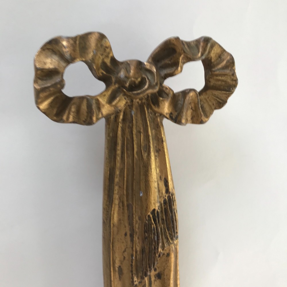 A pair of French carved giltwood wall lights featuring ribbon bow backplates and two scrolling candle arms with acanthus leaf decoration. View III