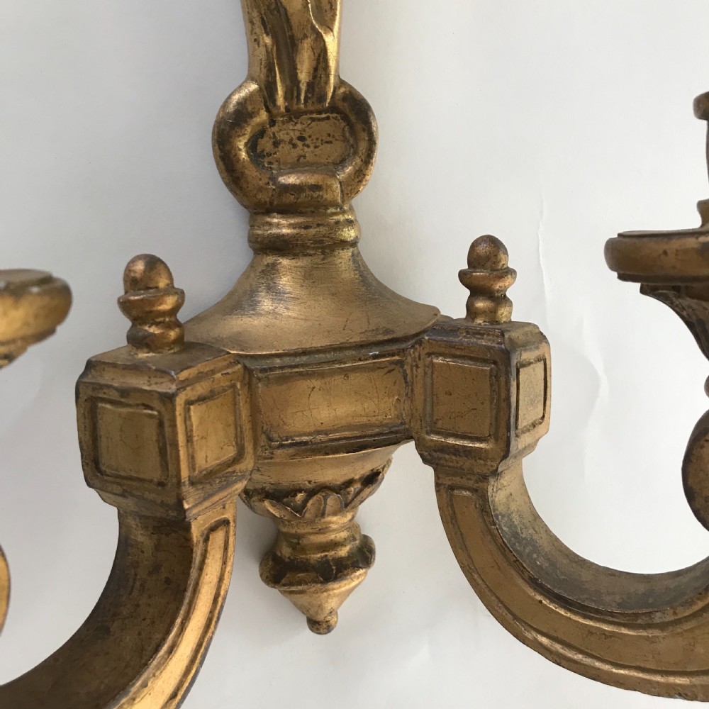 A pair of French carved giltwood wall lights featuring ribbon bow backplates and two scrolling candle arms with acanthus leaf decoration. View VI