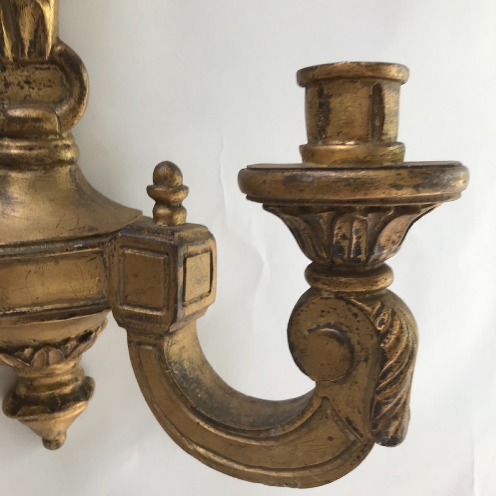A pair of French carved giltwood wall lights featuring ribbon bow backplates and two scrolling candle arms with acanthus leaf decoration. View VII