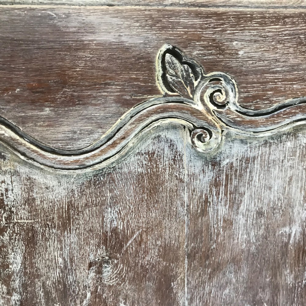 A pair of antique French carved wooden doors featuring a distressed grey painted finish, moulded serpentine panels, and original iron hinges. View IV