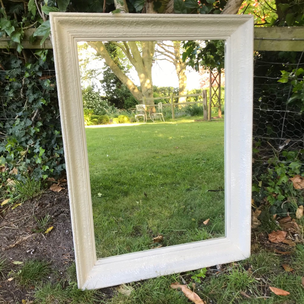 A rectangular off-white painted French framed wall mirror featuring a moulded timber border and reflective glass plate. View II