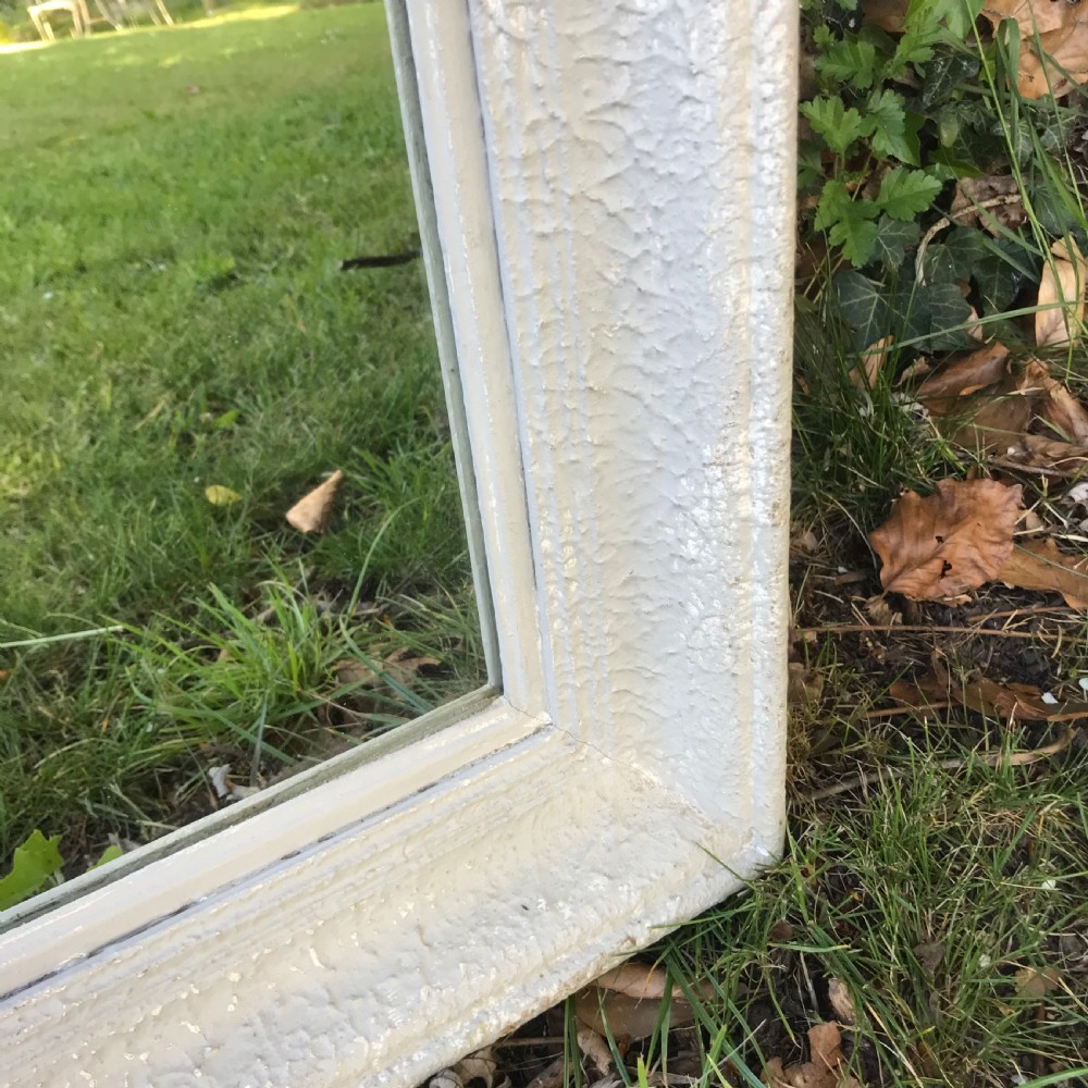 A rectangular off-white painted French framed wall mirror featuring a moulded timber border and reflective glass plate. View V
