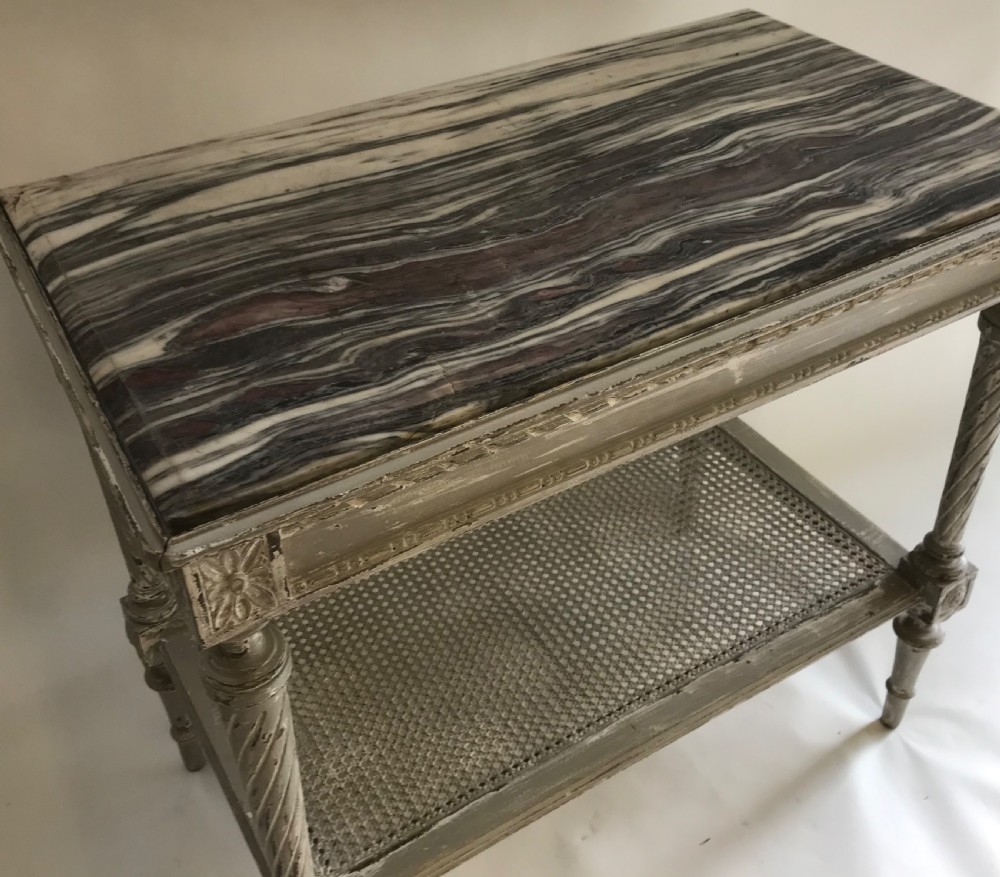 A French Neoclassical style painted wooden side table featuring a dark striated marble top, spiral turned legs, and a woven cane lower shelf. View III