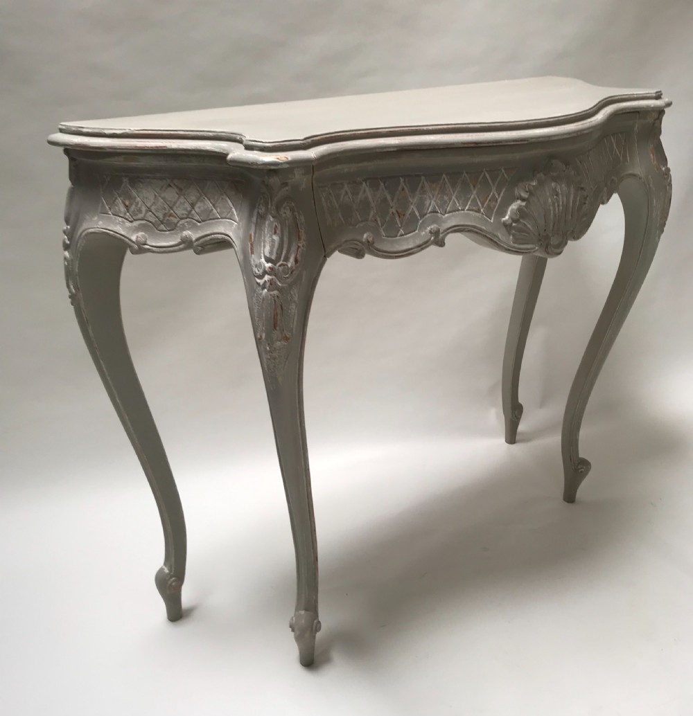 A French Louis XV style grey painted console table featuring cabriole legs, a carved shell motif on the apron, and a serpentine top. View V