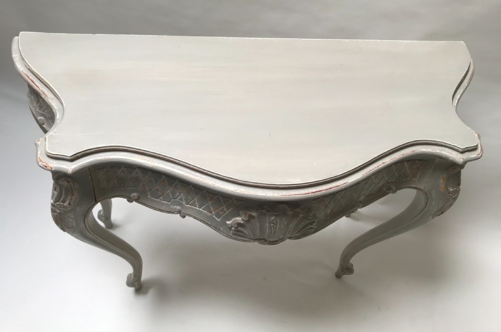 A French Louis XV style grey painted console table featuring cabriole legs, a carved shell motif on the apron, and a serpentine top. View VI