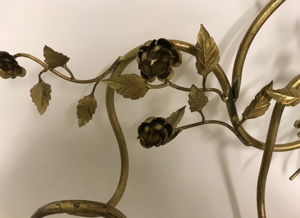 A decorative French gilded metal wall-mounted hook rack featuring elaborate scrollwork, sculpted metal leaves, and flower motifs with four bottom hooks. View V