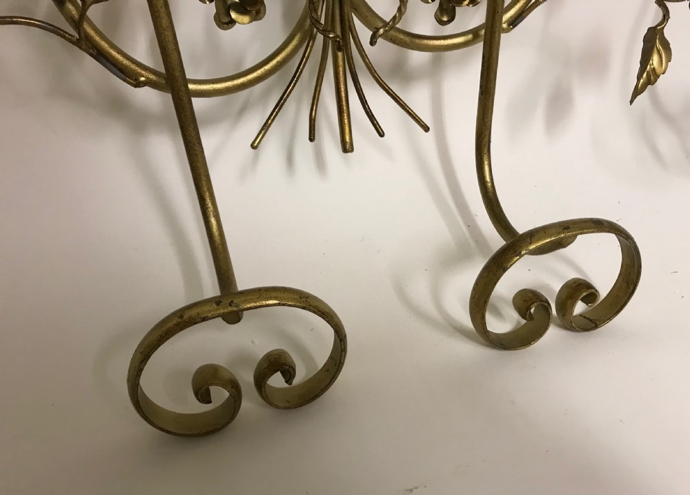 A decorative French gilded metal wall-mounted hook rack featuring elaborate scrollwork, sculpted metal leaves, and flower motifs with four bottom hooks. View VI
