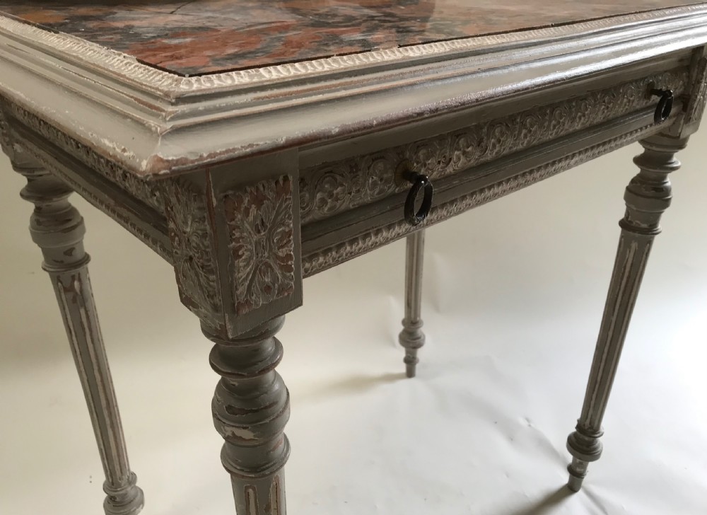 A French painted grey dressing table featuring a variegated reddish-brown marble top, an adjustable central mirror with a carved crest, two small side shelves, and tapered fluted legs. View V