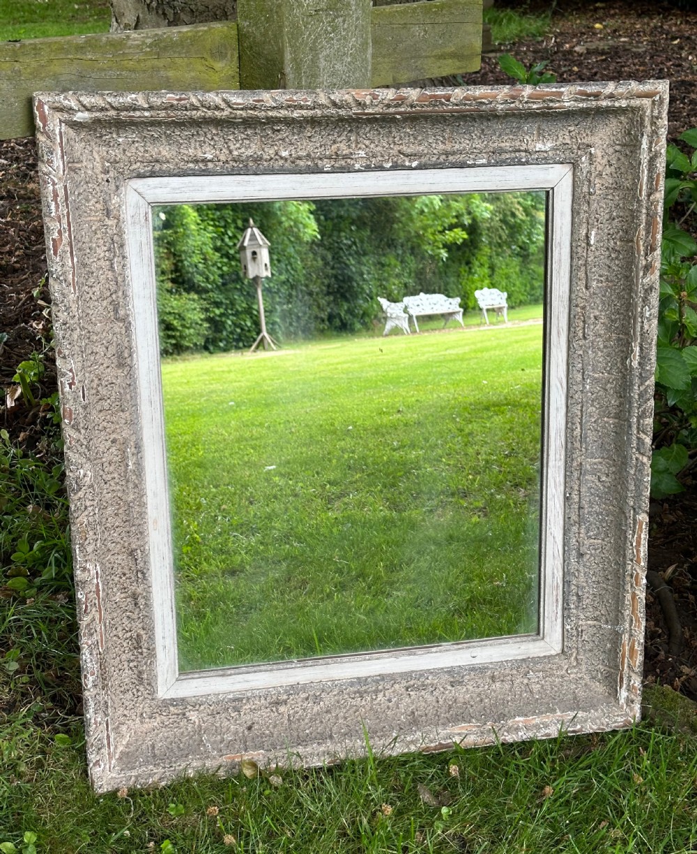 A rectangular wall mirror featuring a heavily distressed pale grey painted wooden frame with carved edge details. View IV