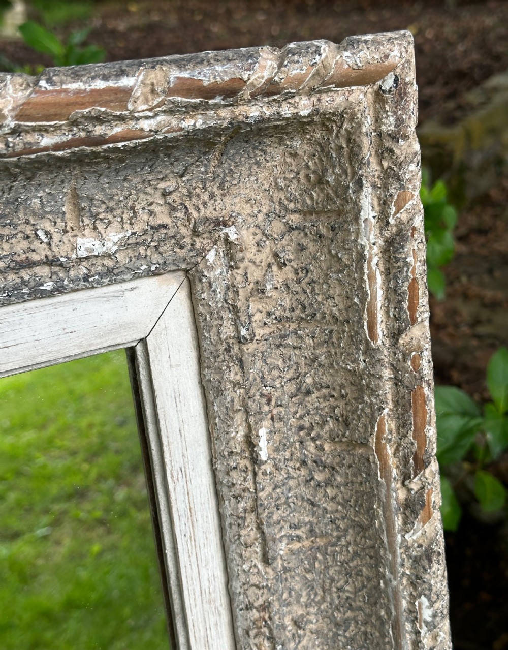 A rectangular wall mirror featuring a heavily distressed pale grey painted wooden frame with carved edge details. View V