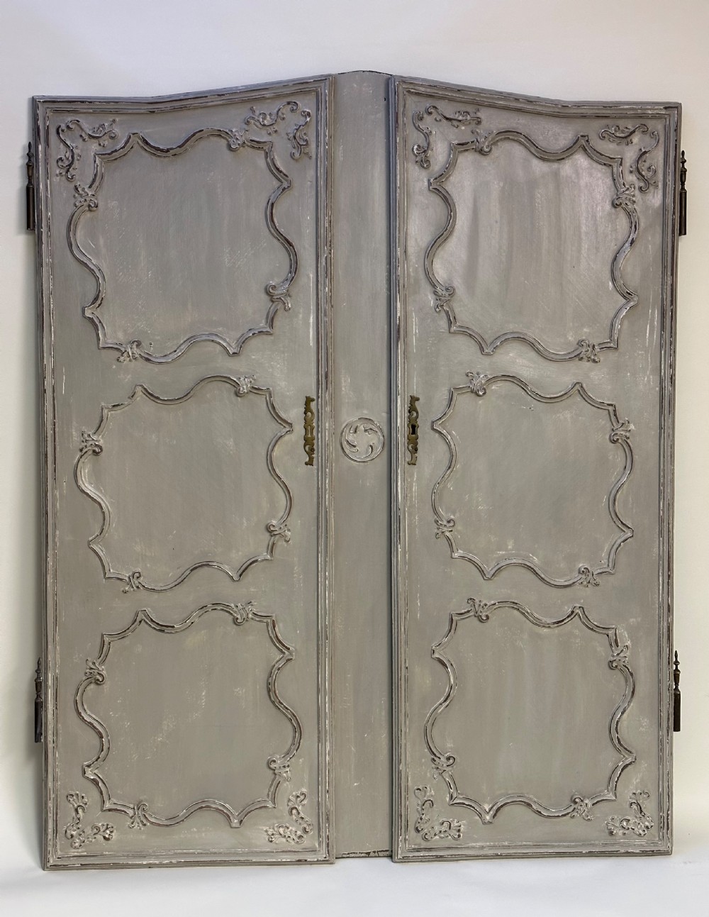 A pair of grey painted French timber doors featuring hand-carved Rococo style panel mouldings and metal hardware.