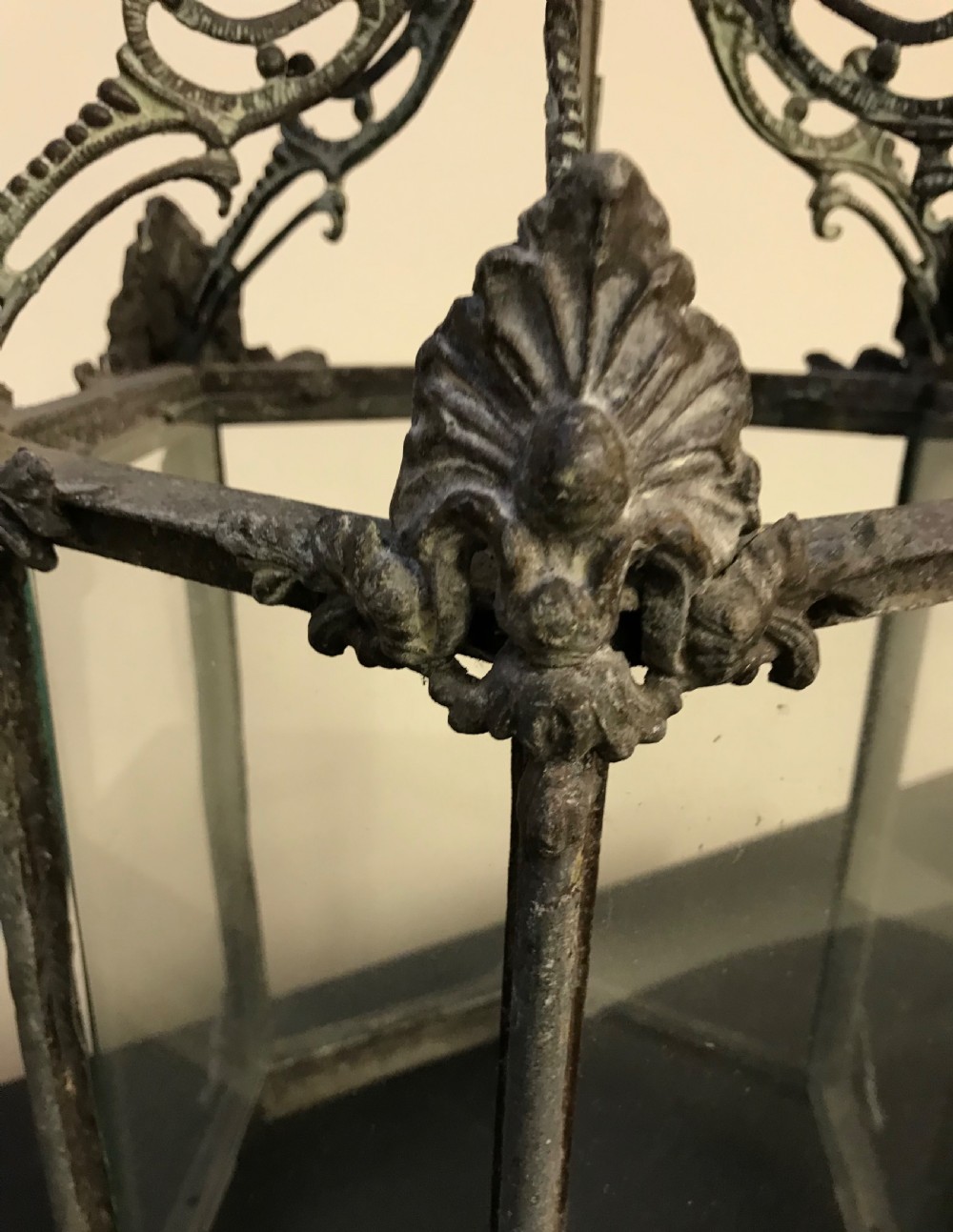 A hexagonal weathered metal hanging lantern featuring clear glass panels, an ornate pierced crown, and an internal brass bulb fitting. View II