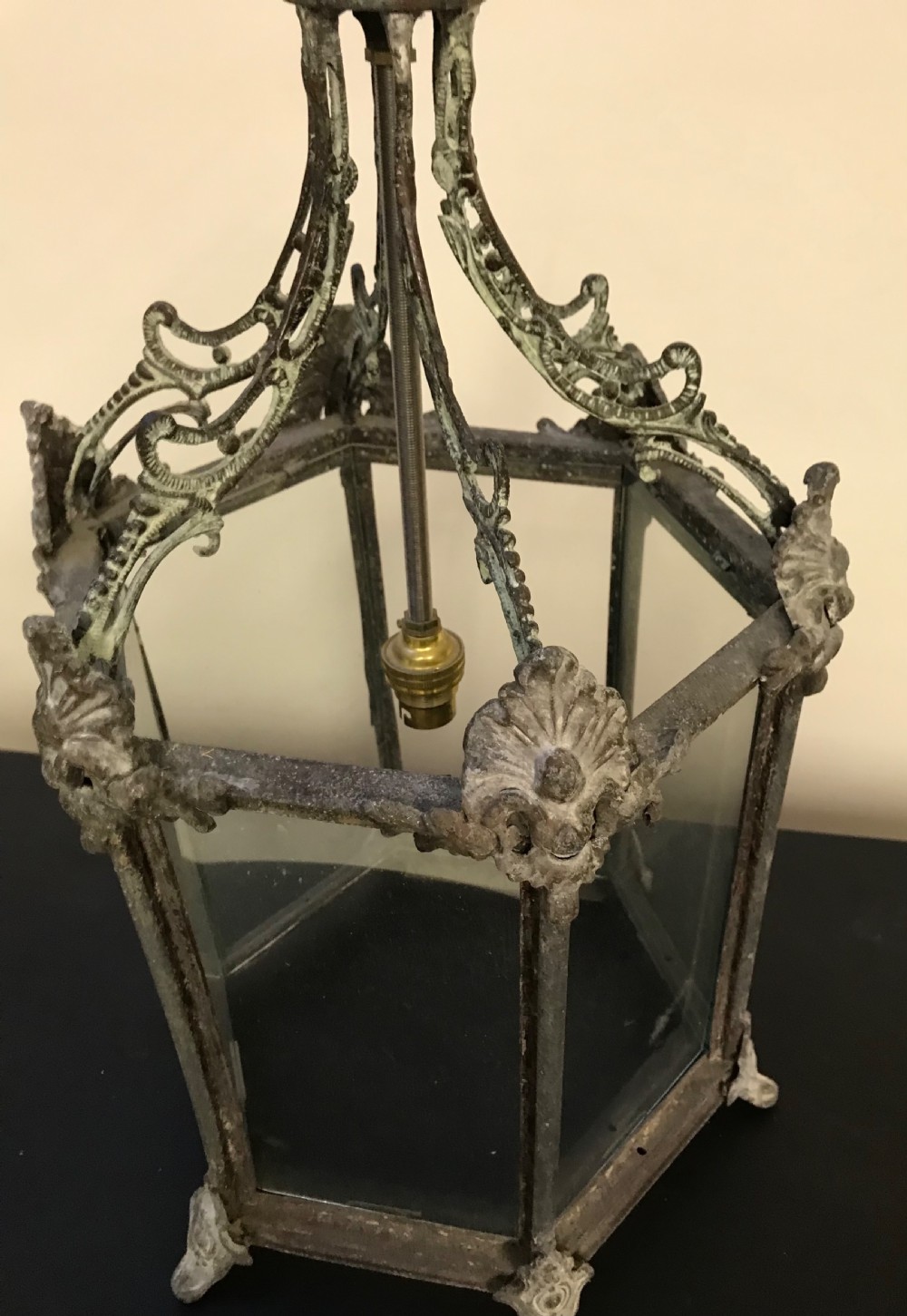 A hexagonal weathered metal hanging lantern featuring clear glass panels, an ornate pierced crown, and an internal brass bulb fitting. View III