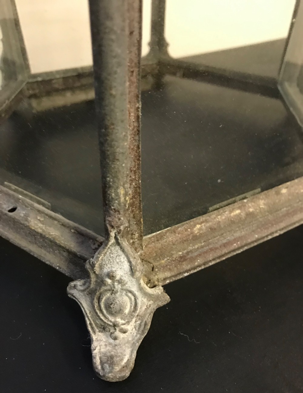 A hexagonal weathered metal hanging lantern featuring clear glass panels, an ornate pierced crown, and an internal brass bulb fitting. View IV