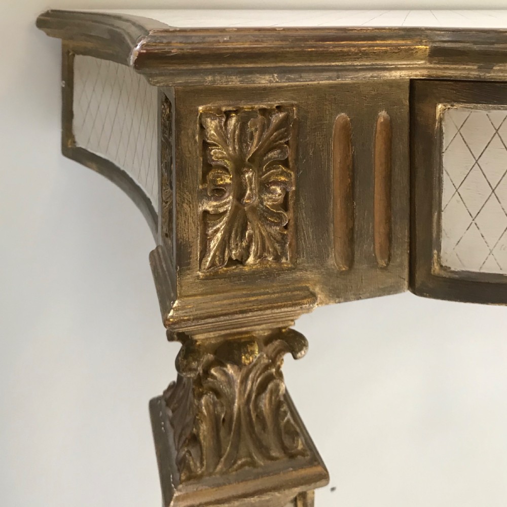 A French Neoclassical style console table with a cream diamond-patterned top, central drawer with a tassel pull, and gilded tapered legs. View III
