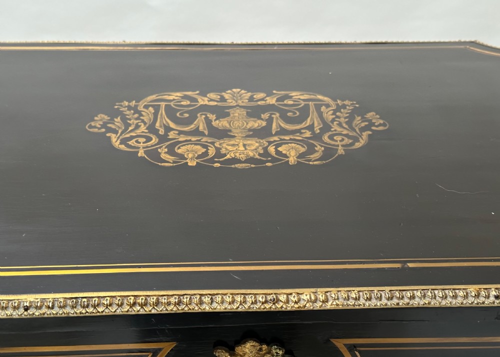 An ebonised Napoleon III drop-leaf table featuring gilt brass mounts, incised inlay, and turned legs joined by a curved stretcher. View XI