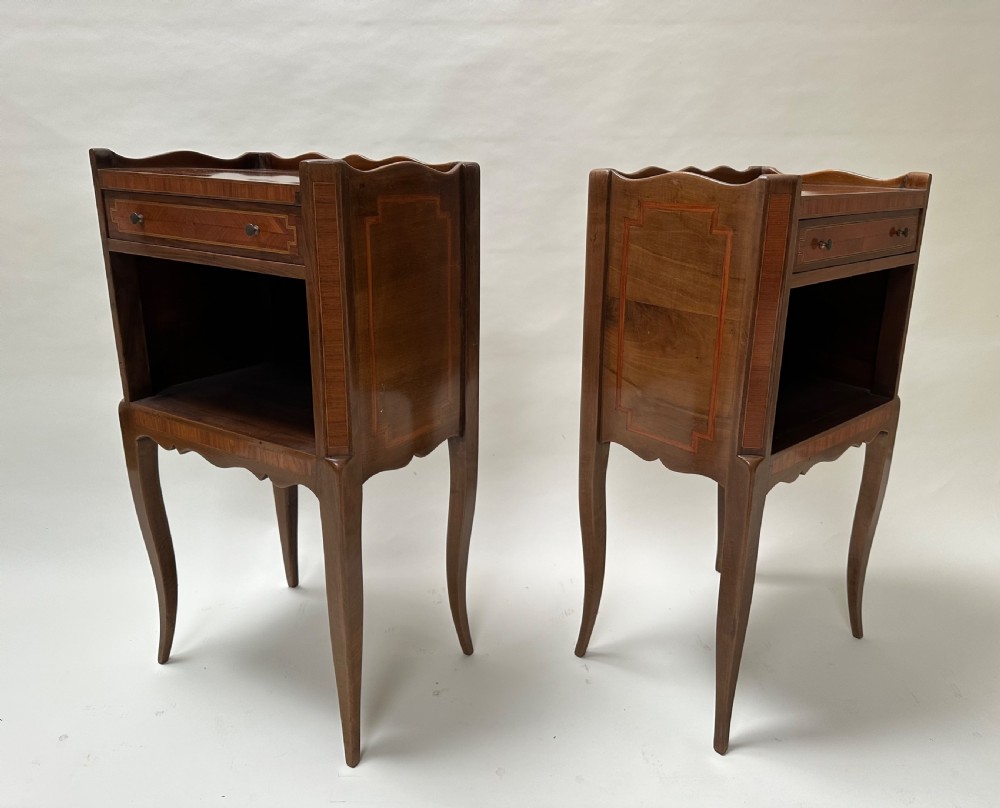 A pair of French Louis XV style warm brown walnut bedside tables featuring geometric parquetry inlay, shaped galleries, and slender cabriole legs. View VII