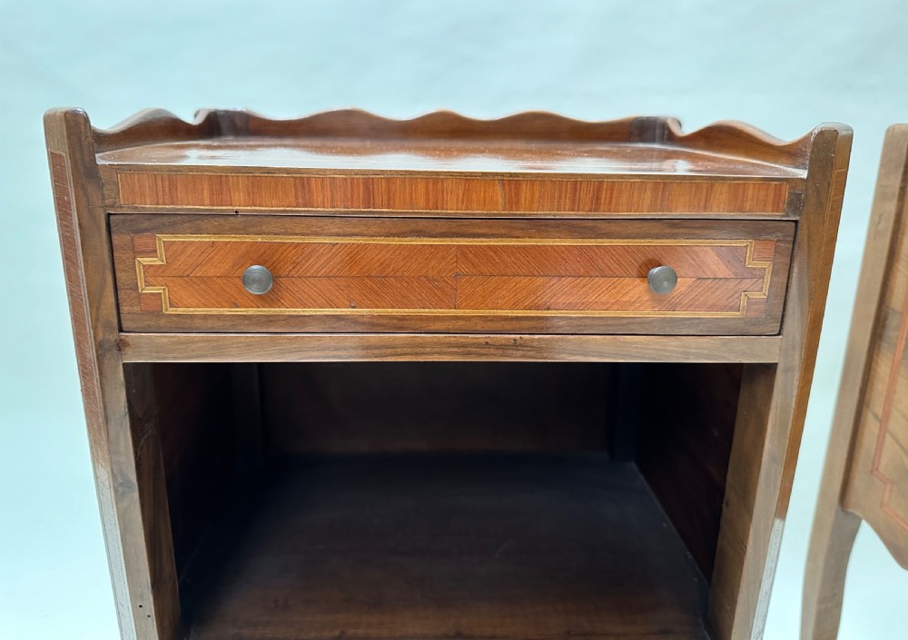 A pair of French Louis XV style warm brown walnut bedside tables featuring geometric parquetry inlay, shaped galleries, and slender cabriole legs. View VIII
