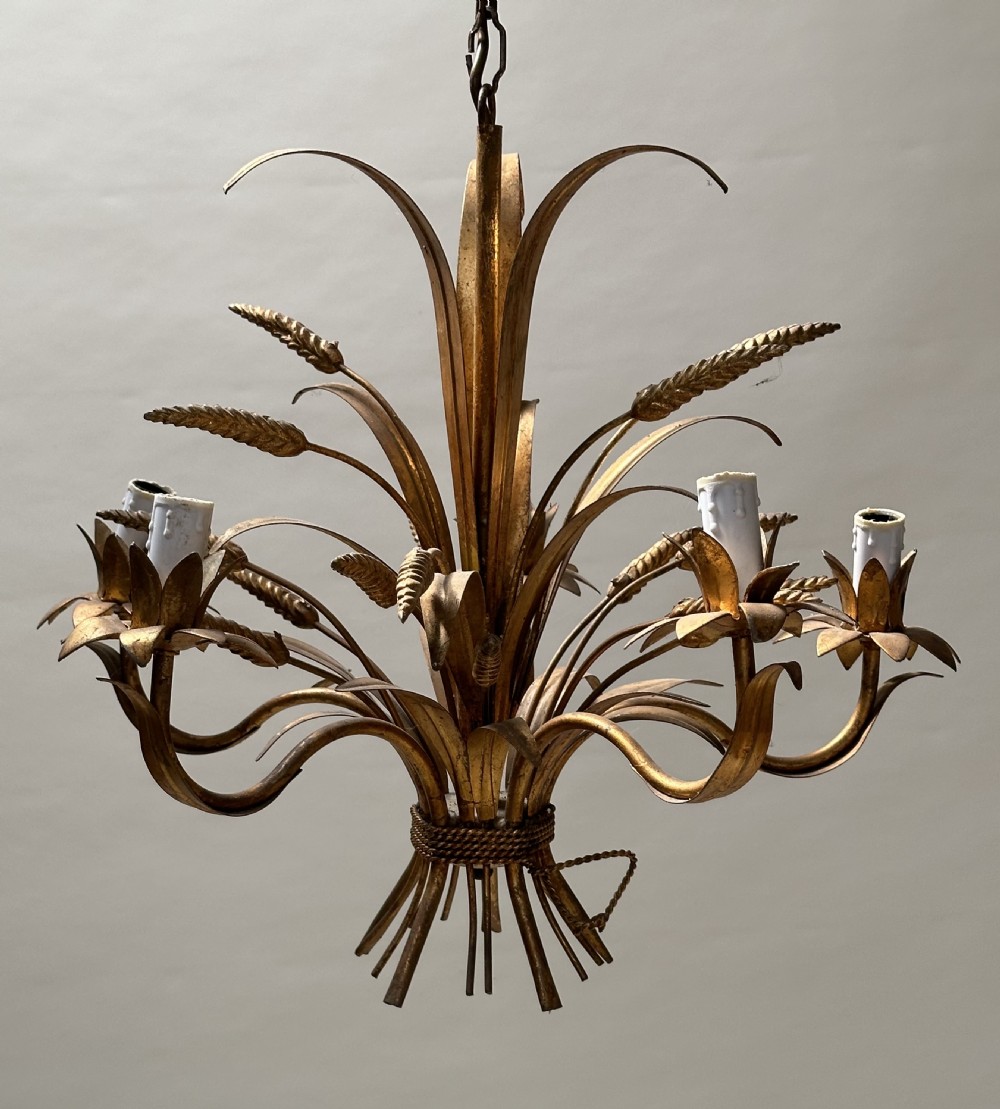 A French gilded metal chandelier crafted in the form of a tied sheaf of wheat with sculpted leaves and five candle bulb sleeves.