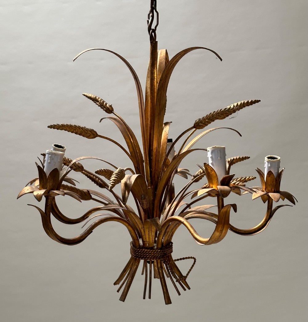 A French gilded metal chandelier crafted in the form of a tied sheaf of wheat with sculpted leaves and five candle bulb sleeves. View V