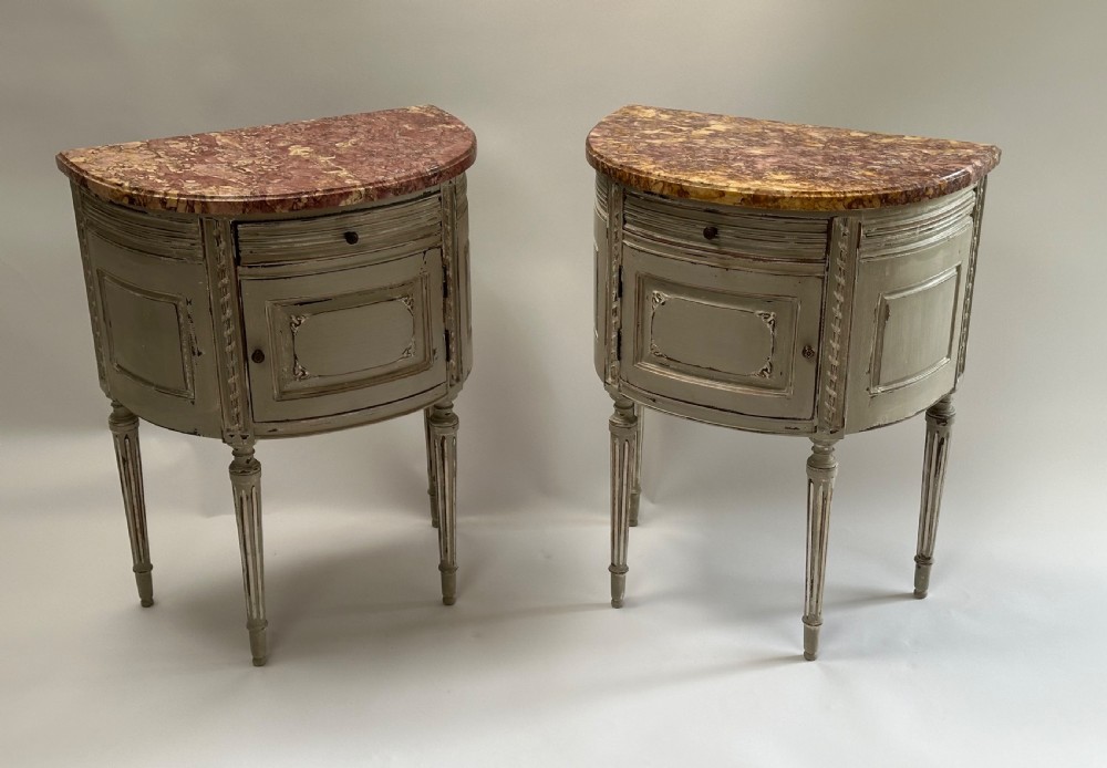 A pair of grey painted demi-lune bedside tables with variegated red marble tops and fluted tapering legs. View II