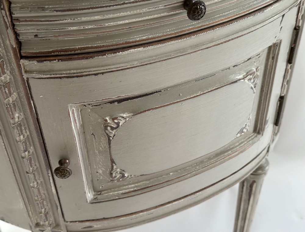 A pair of grey painted demi-lune bedside tables with variegated red marble tops and fluted tapering legs. View III