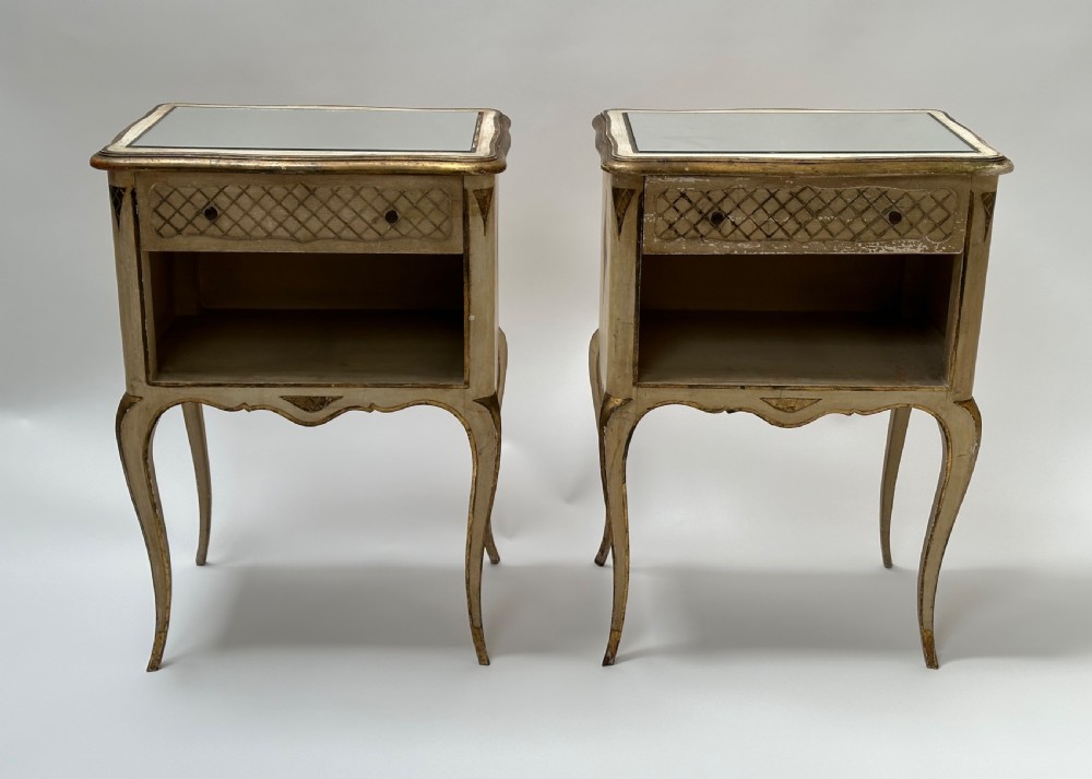 A pair of cream and gold Florentine bedside tables featuring mirrored tops, open lower compartments, carved lattice drawers, and slender cabriole legs. View III