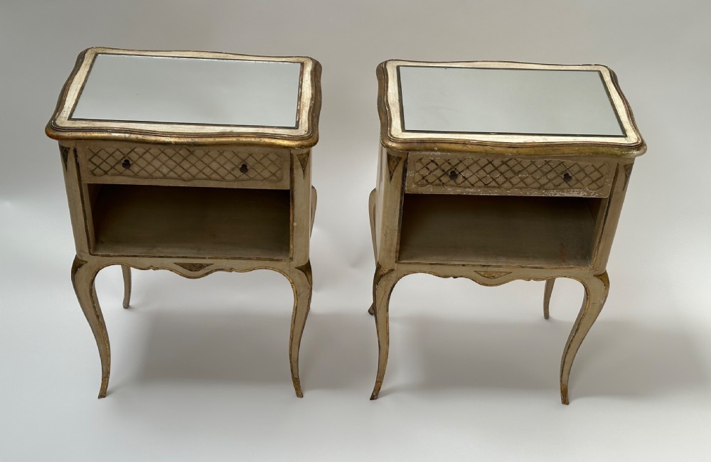 A pair of cream and gold Florentine bedside tables featuring mirrored tops, open lower compartments, carved lattice drawers, and slender cabriole legs. View IV