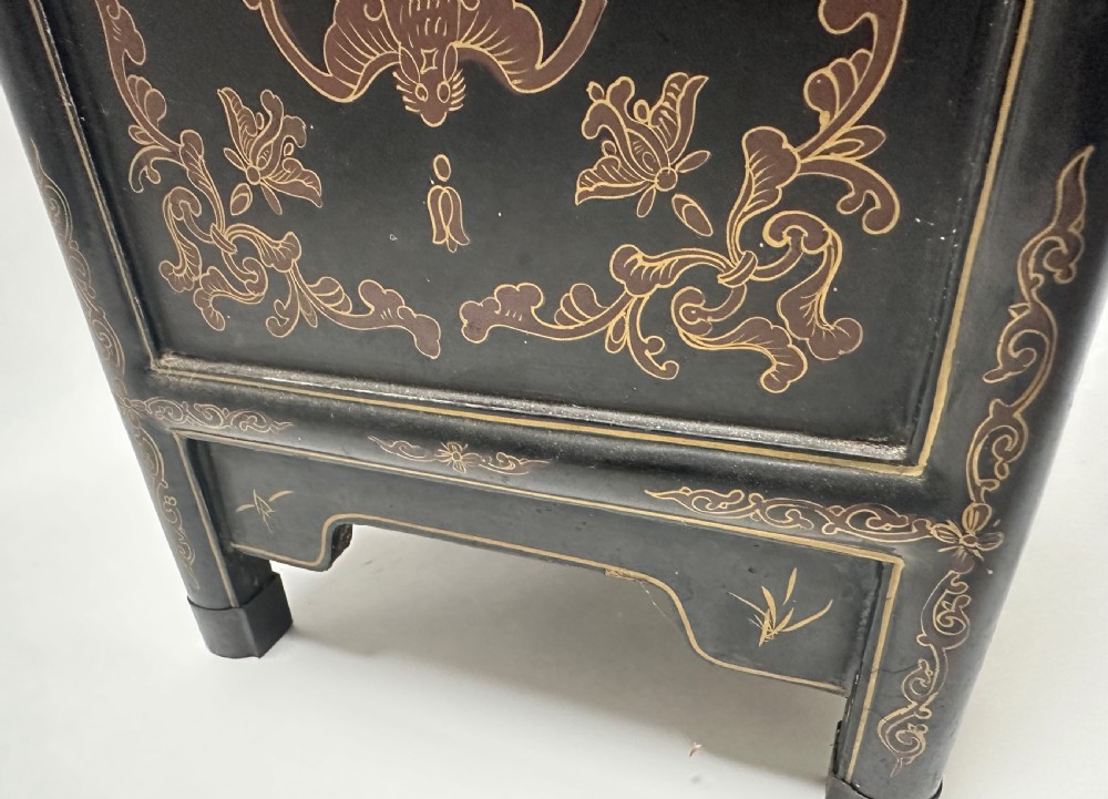 A pair of black lacquered two-door Chinoiserie cabinets featuring carved hardstone inlays of horses, animals, and vessels, topped with gilt scrollwork motifs. View VIII