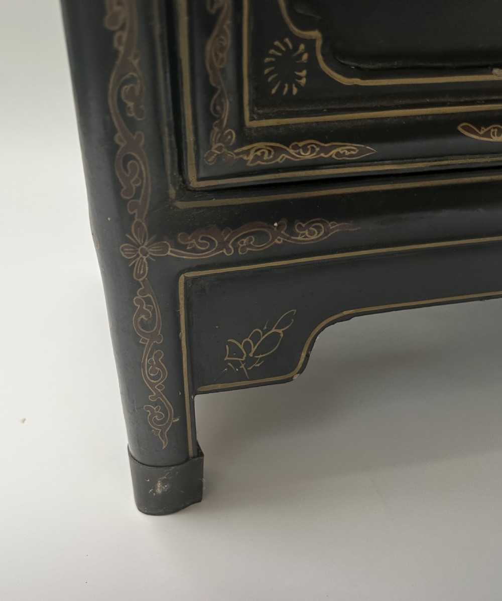A pair of black lacquered two-door Chinoiserie cabinets featuring carved hardstone inlays of horses, animals, and vessels, topped with gilt scrollwork motifs. View IX