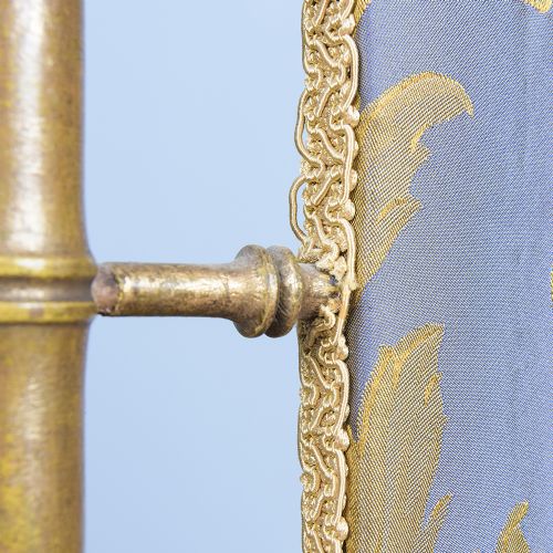 A Regency faux bamboo brass fire screen with an upholstered purple panel displaying gold acanthus leaf scrollwork. View VI