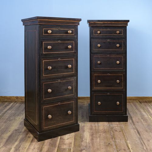 fig 1. A pair of tall Victorian laburnum Wellington chests with five graduated drawers, fine string inlay, turned wooden knobs, and plinth bases.