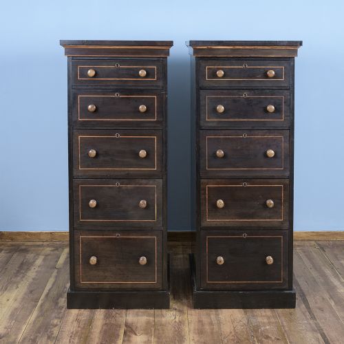A pair of tall Victorian laburnum Wellington chests with five graduated drawers, fine string inlay, turned wooden knobs, and plinth bases.