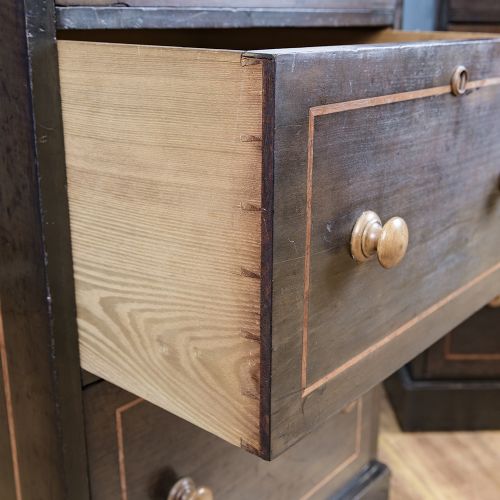 A pair of tall Victorian laburnum Wellington chests with five graduated drawers, fine string inlay, turned wooden knobs, and plinth bases. View VII