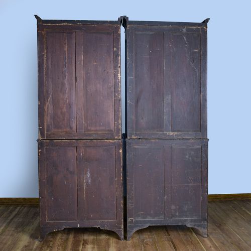 fig 7. A pair of tall George III mahogany bookcases featuring oval astragal glazed upper doors above deep drawers and flame mahogany panelled cupboard bases.