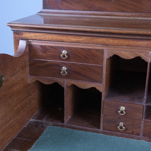 fig 9. A pair of tall George III mahogany bookcases featuring oval astragal glazed upper doors above deep drawers and flame mahogany panelled cupboard bases.