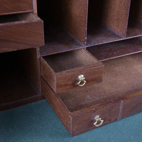 A pair of tall George III mahogany bookcases featuring oval astragal glazed upper doors above deep drawers and flame mahogany panelled cupboard bases. View XI