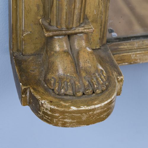 A rectangular Regency giltwood overmantel mirror framed with Egyptian revival term pilasters, sculpted head capitals, and an architectural molded cornice. View VI