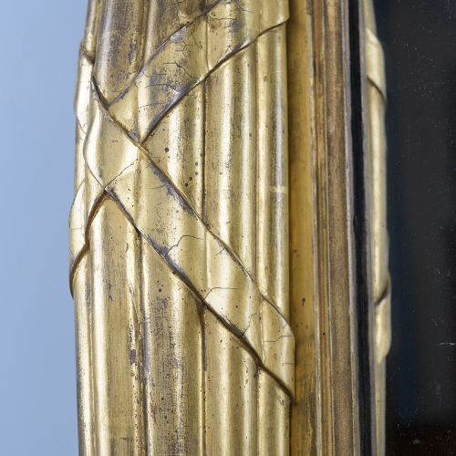 A rectangular Regency giltwood overmantel mirror framed with Egyptian revival term pilasters, sculpted head capitals, and an architectural molded cornice. View VIII