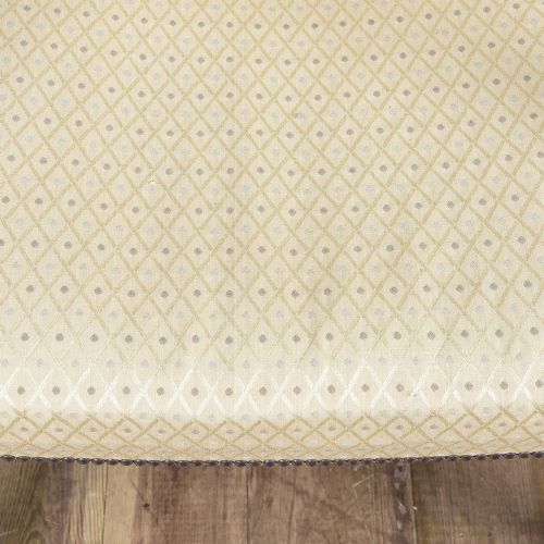 A George III mahogany Gainsborough armchair featuring patterned cream upholstery, brass tack trim, carved serpentine arm supports, and straight legs with brass castors. View VIII