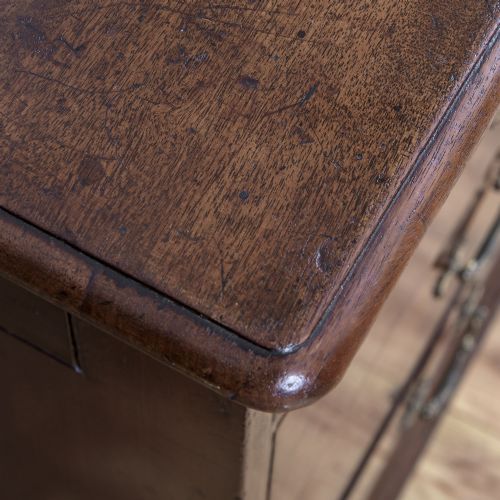 A George II Cuban mahogany chest featuring brass drop handles, keyhole escutcheons, a top brushing slide, two short drawers, two long drawers, and bracket feet. View VI