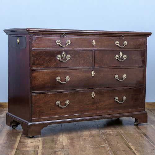 A George II Cuban mahogany chest featuring brass drop handles, keyhole escutcheons, a top brushing slide, two short drawers, two long drawers, and bracket feet. View VIII