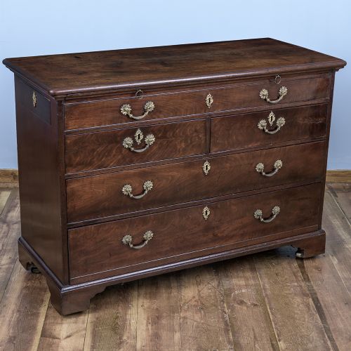 A George II Cuban mahogany chest featuring brass drop handles, keyhole escutcheons, a top brushing slide, two short drawers, two long drawers, and bracket feet. View IX