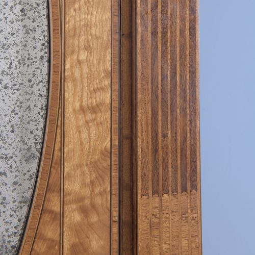 A tall George III satinwood cabinet with an oval-mirrored upper door, a central drawer, and lower double doors with oval inlaid panels. View VII