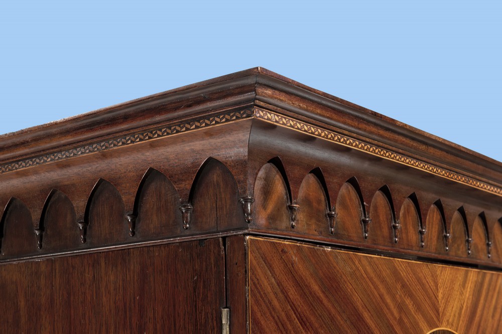 An 18th-century Hepplewhite mahogany clothes press featuring double doors with flame mahogany oval panels over a single long base drawer. View III