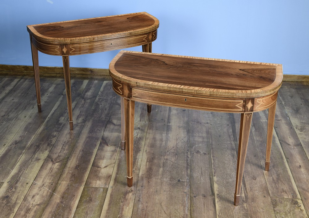 A pair of late 18th-century demi-lune card tables crafted from dark rosewood with contrasting satinwood crossbanding and tapered legs. View III
