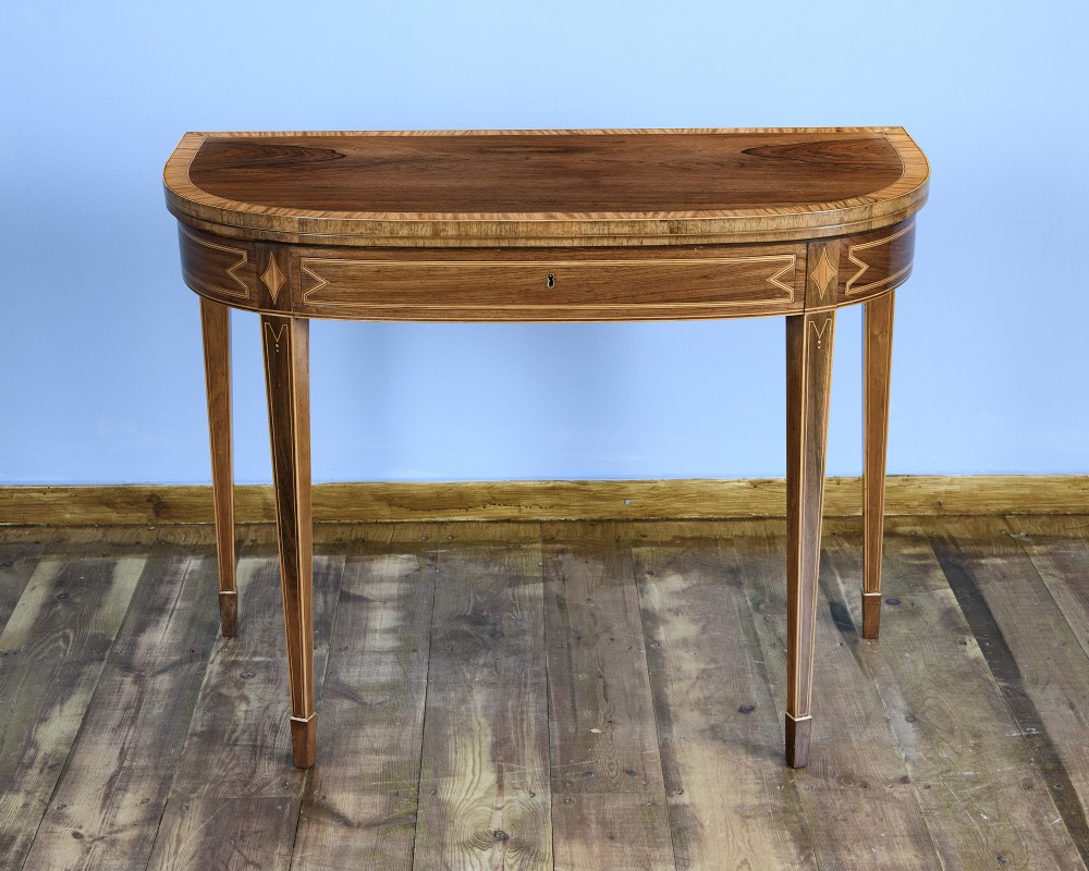A pair of late 18th-century demi-lune card tables crafted from dark rosewood with contrasting satinwood crossbanding and tapered legs. View IV